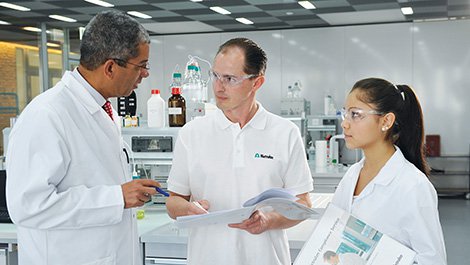 Lab-staff-talking-with-documents.jpg